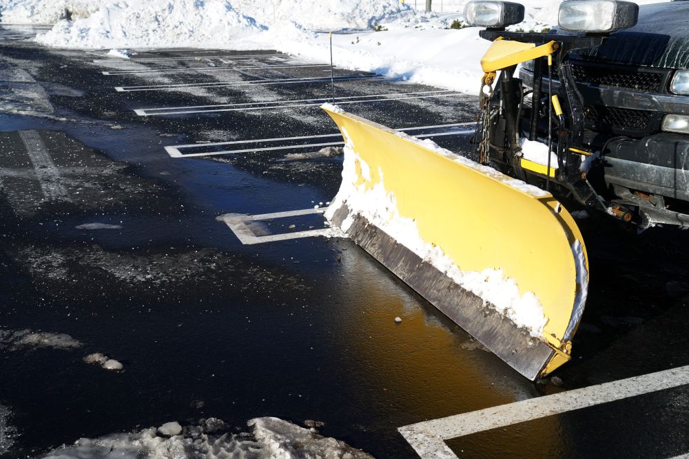 Snow plow in parking lot